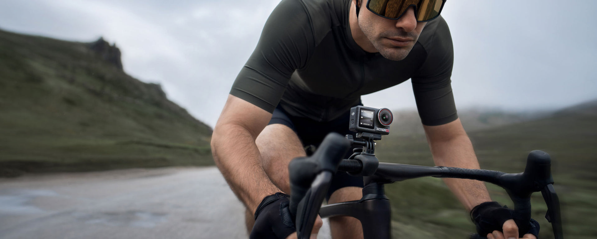 A man using the DJI Osmo Action 5 Pro camera whilst riding his bike